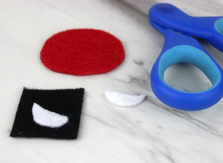 Use the white and black felt to cut out eyes and snout details. 
